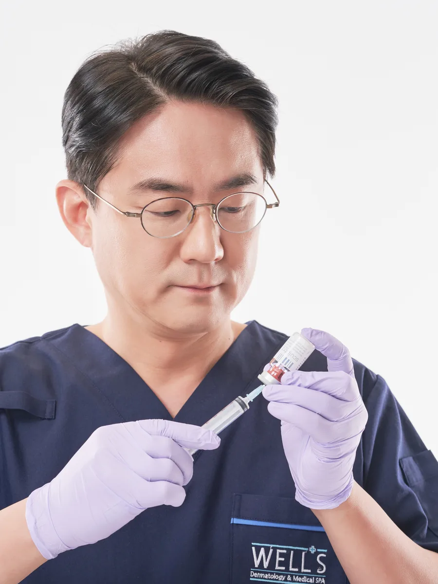 Dr. Choi preparing an injectable treatment at Wells Clinic